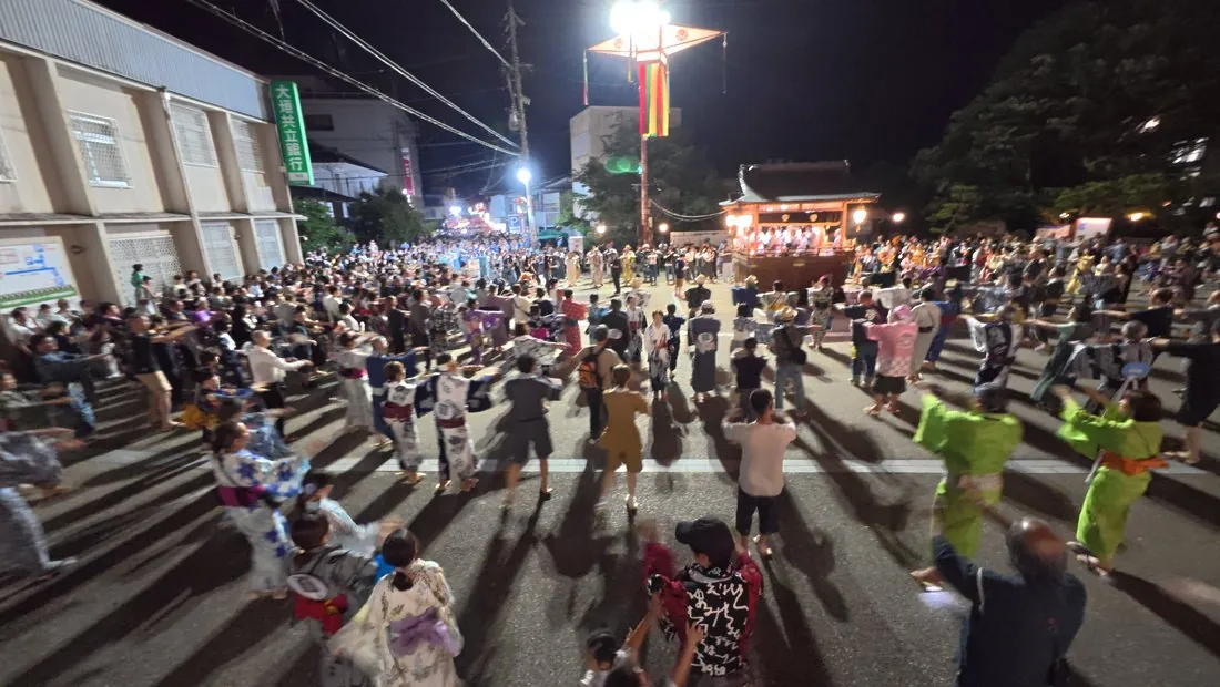 The dance circle on opening night: yukata of every pattern mixed freely with T-shirts, backpacks and everyday clothes — nobody is checking